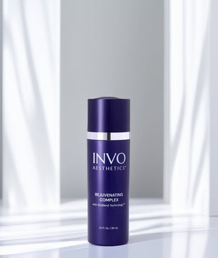 INVOC Skincare bottle on a reflective surface with a neutral background